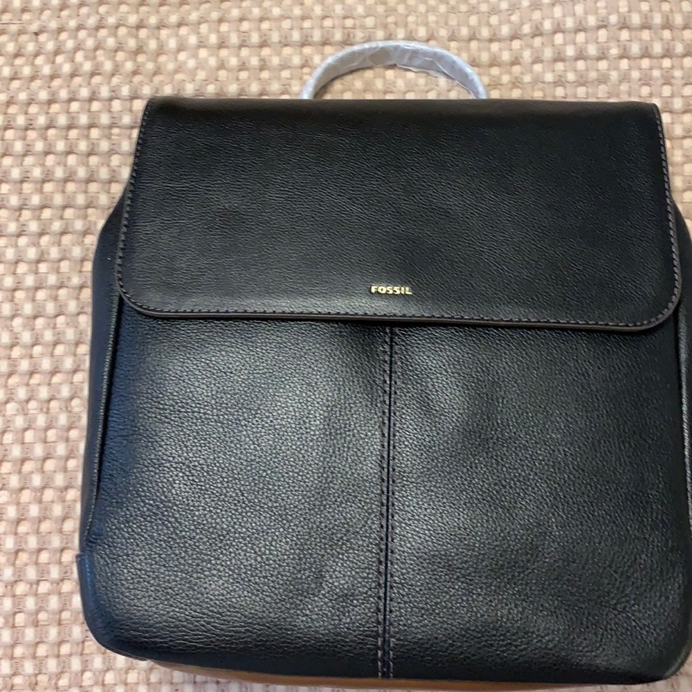 NWT Fossil backpack. Black with brown trim, brass hardware. One side zip pocket.